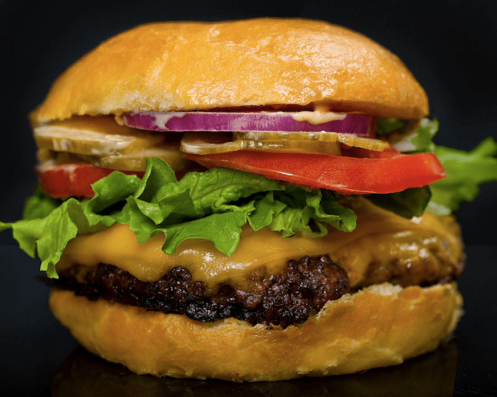 Hamburger-ground-beef-patty-in-a-bun-often-with-lettuce-tomato,-cheese-pickles